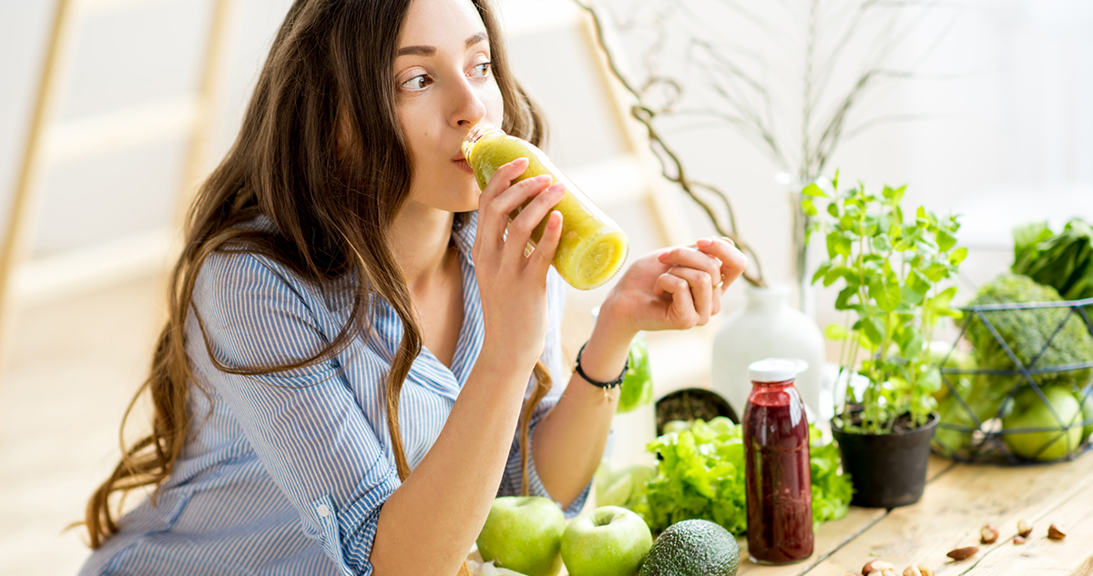 fiatal nő egészséges ételeket eszik, smoothiet iszik, teherbeesést segítő ételek